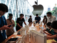 Customers try out the latest iPhone 16 models at an Apple store in Bangkok, Thailand, on September 20, 2024. Apple now makes available to co...