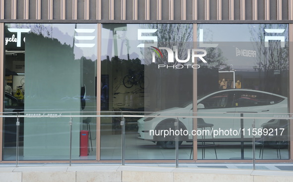 A new electric car is displayed at a new Tesla store in Shanghai, China, on August 9, 2024. 