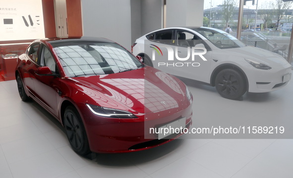 New electric cars are displayed at a new Tesla store in Shanghai, China, on August 9, 2024. 