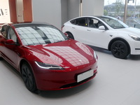 New electric cars are displayed at a new Tesla store in Shanghai, China, on August 9, 2024. (