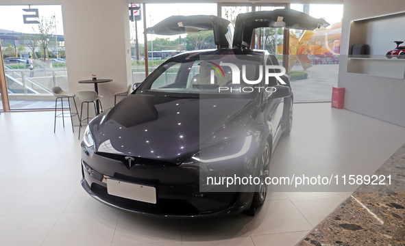 A new electric car is displayed at a new Tesla store in Shanghai, China, on August 9, 2024. 