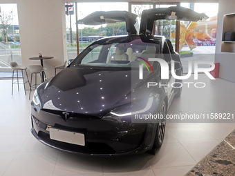 A new electric car is displayed at a new Tesla store in Shanghai, China, on August 9, 2024. (