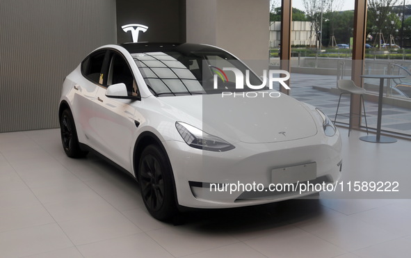 A new electric car is displayed at a new Tesla store in Shanghai, China, on August 9, 2024. 