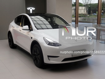 A new electric car is displayed at a new Tesla store in Shanghai, China, on August 9, 2024. (