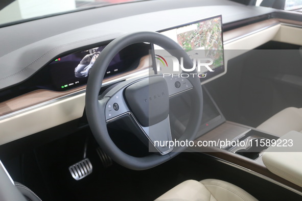 A new electric car is displayed at a new Tesla store in Shanghai, China, on August 9, 2024. 