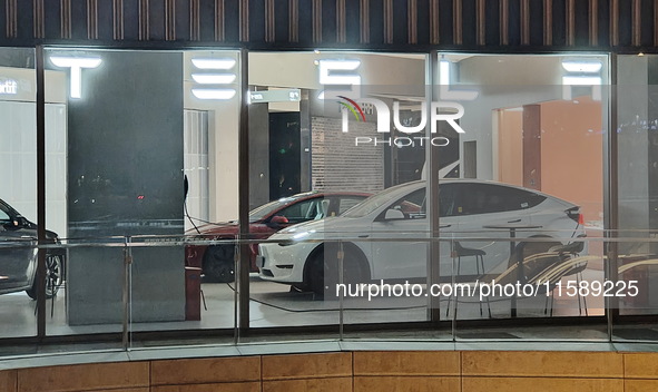 New electric cars are displayed at a new Tesla store in Shanghai, China, on August 9, 2024. 