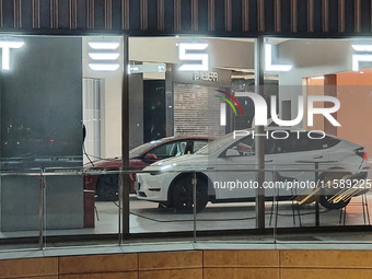 New electric cars are displayed at a new Tesla store in Shanghai, China, on August 9, 2024. (