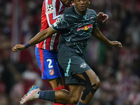 Lois Openda centre-forward of RB Leipzig and Belgium and Jose Maria Gimenez centre-back of Atletico de Madrid and Uruguay compete for the ba...