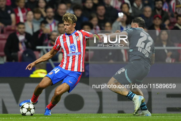 Marcos Llorente central midfield of Atletico de Madrid and Spain and David Raum left-Back of RB Leipzig and Germany compete for the ball dur...