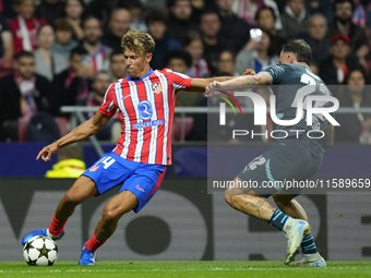 Marcos Llorente central midfield of Atletico de Madrid and Spain and David Raum left-Back of RB Leipzig and Germany compete for the ball dur...