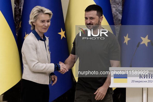 European Commission President Ursula Von Der Leyen shakes hands with Ukrainian President Volodymyr Zelenskiy after a joint press conference...