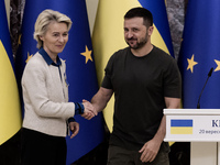 European Commission President Ursula Von Der Leyen shakes hands with Ukrainian President Volodymyr Zelenskiy after a joint press conference...