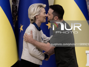 European Commission President Ursula Von Der Leyen shakes hands with Ukrainian President Volodymyr Zelenskiy after a joint press conference...