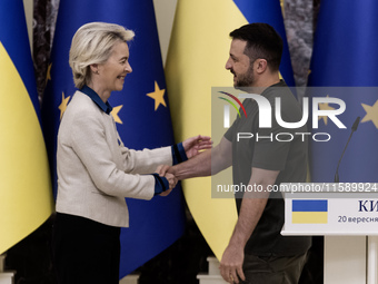 European Commission President Ursula Von Der Leyen shakes hands with Ukrainian President Volodymyr Zelenskiy after a joint press conference...