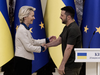 European Commission President Ursula Von Der Leyen shakes hands with Ukrainian President Volodymyr Zelenskiy after a joint press conference...