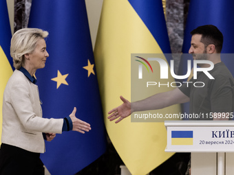 European Commission President Ursula Von Der Leyen shakes hands with Ukrainian President Volodymyr Zelenskiy after a joint press conference...