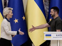 European Commission President Ursula Von Der Leyen shakes hands with Ukrainian President Volodymyr Zelenskiy after a joint press conference...