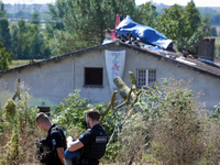 Two gendarmes stand guard in front of the 'Verger' house where a banner reads 'ZAD'. For the fourth day, the Gendarmerie and CNAMO try to di...