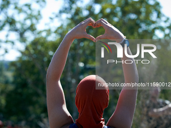 A zadist makes a 'love' sign to squirrels living in the trees of the 'Verger' ZAD. For the fourth day, Gendarmerie and CNAMO try to dislodge...