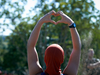 A zadist makes a 'love' sign to squirrels living in the trees of the 'Verger' ZAD. For the fourth day, Gendarmerie and CNAMO try to dislodge...