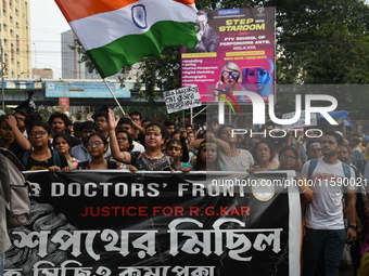 Doctors and citizens shout slogans and participate in a protest march to condemn the rape and murder of a doctor in Kolkata, India, on Septe...