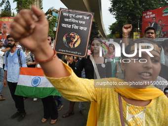 Doctors and citizens shout slogans and participate in a protest march to condemn the rape and murder of a doctor in Kolkata, India, on Septe...