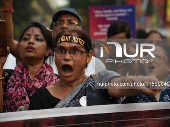 Doctors and citizens shout slogans and participate in a protest march to condemn the rape and murder of a doctor in Kolkata, India, on Septe...