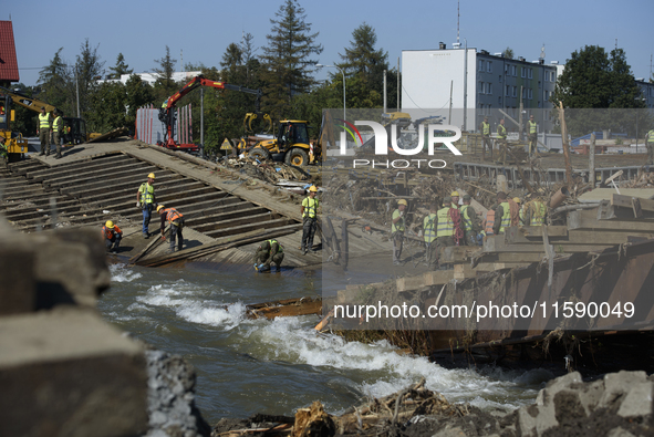 Members of the Polish armed forces and workers remove remnants of a bridge in the flood-hit town of Glucholazy, Poland, on September 20, 202...