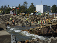 Members of the Polish armed forces and workers remove remnants of a bridge in the flood-hit town of Glucholazy, Poland, on September 20, 202...