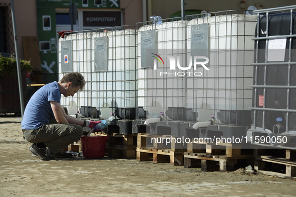 A man collects water in Glucholazy, Poland, on September 20, 2024. 