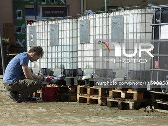 A man collects water in Glucholazy, Poland, on September 20, 2024. (