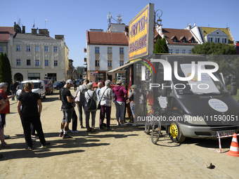 People queue for food at a World Central Kitchen truck in Glucholazy, Poland, on September 20, 2024. (