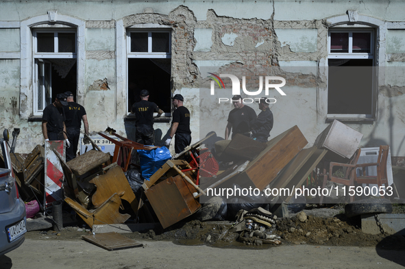 Firefighters clean the flooding aftermath in Glucholazy, Poland, on September 20, 2024. 