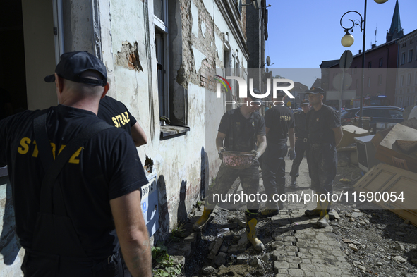 Firefighters clean the flooding aftermath in Glucholazy, Poland, on September 20, 2024. 