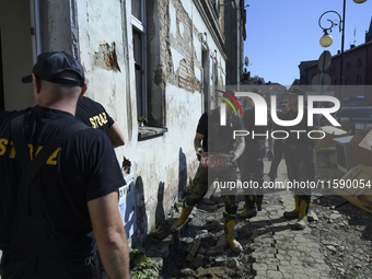 Firefighters clean the flooding aftermath in Glucholazy, Poland, on September 20, 2024. (