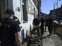 Firefighters clean the flooding aftermath in Glucholazy, Poland, on September 20, 2024. (