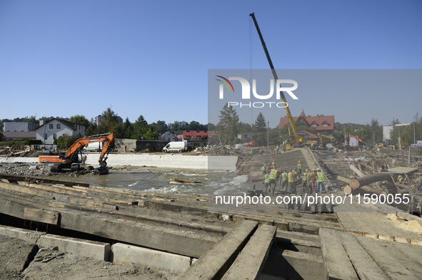 Members of the Polish armed forces and workers remove remnants of a bridge in the flood-hit town of Glucholazy, Poland, on September 20, 202...