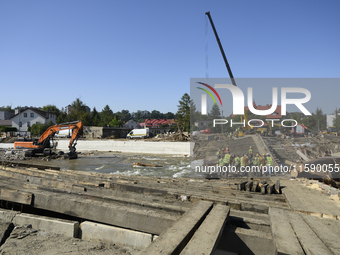 Members of the Polish armed forces and workers remove remnants of a bridge in the flood-hit town of Glucholazy, Poland, on September 20, 202...