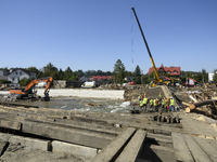 Members of the Polish armed forces and workers remove remnants of a bridge in the flood-hit town of Glucholazy, Poland, on September 20, 202...