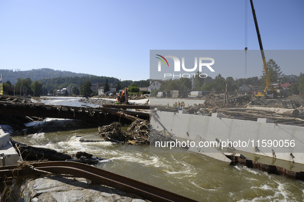 Members of the Polish armed forces and workers remove remnants of a bridge in the flood-hit town of Glucholazy, Poland, on September 20, 202...