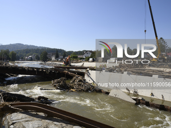 Members of the Polish armed forces and workers remove remnants of a bridge in the flood-hit town of Glucholazy, Poland, on September 20, 202...