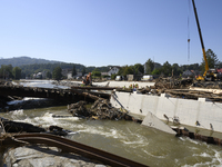 Members of the Polish armed forces and workers remove remnants of a bridge in the flood-hit town of Glucholazy, Poland, on September 20, 202...