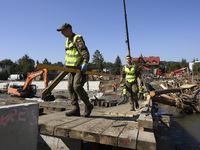 Members of the Polish armed forces and workers remove remnants of a bridge in the flood-hit town of Glucholazy, Poland, on September 20, 202...