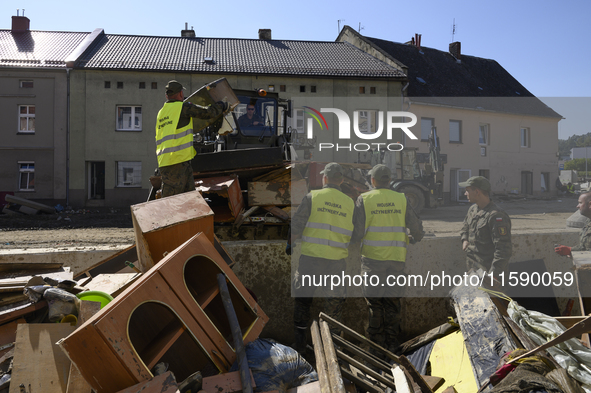 Members of the Polish armed forces help clean the flooding aftermath in Glucholazy, Poland, on September 20, 2024. 