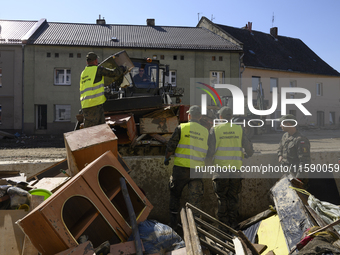 Members of the Polish armed forces help clean the flooding aftermath in Glucholazy, Poland, on September 20, 2024. (