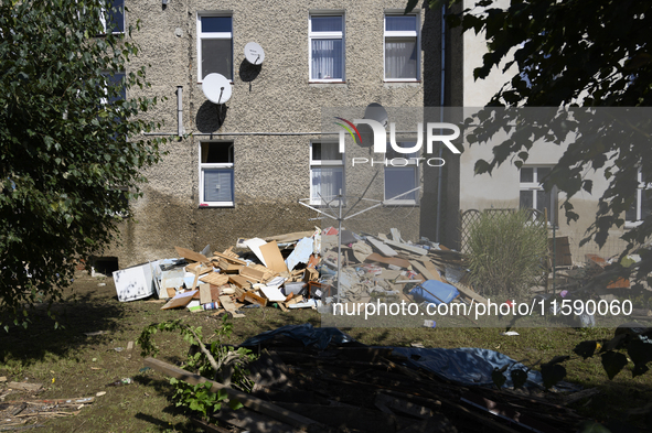 Furniture and other goods amass against a house in the flood-hit town of Glucholazy, Poland, on September 20, 2024. 