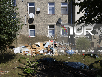 Furniture and other goods amass against a house in the flood-hit town of Glucholazy, Poland, on September 20, 2024. (