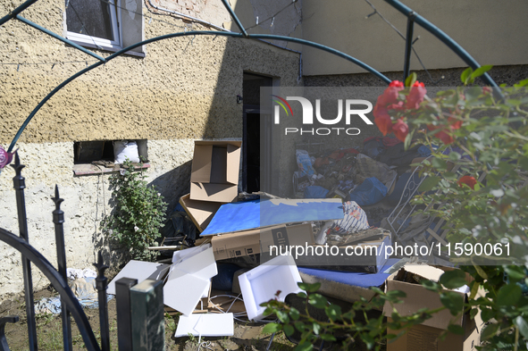 Furniture and other goods amass against a house in the flood-hit town of Glucholazy, Poland, on September 20, 2024. 