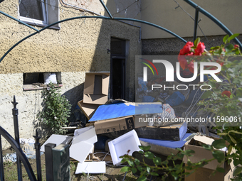 Furniture and other goods amass against a house in the flood-hit town of Glucholazy, Poland, on September 20, 2024. (