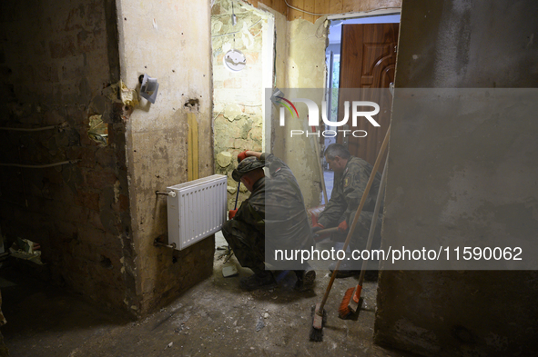 Members of the Polish armed forces clean up a house after the flood in Glucholazy, Poland, on September 20, 2024. 